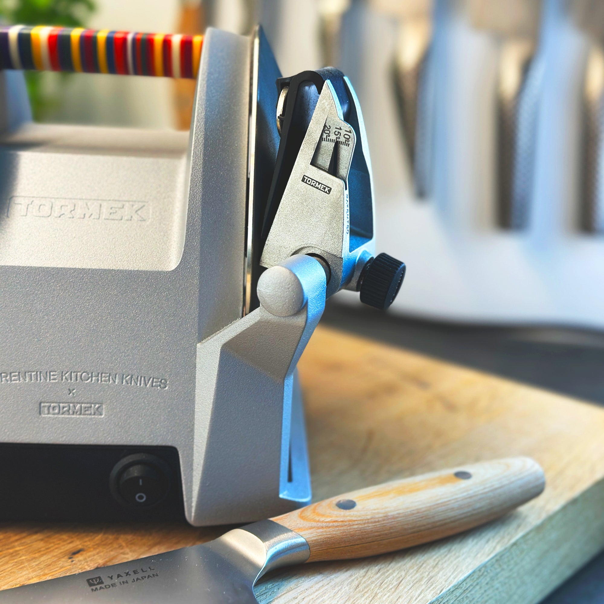 A picture of Tormek T-1 Florentine Vibrant with focal point of the patented guide and a knive below.