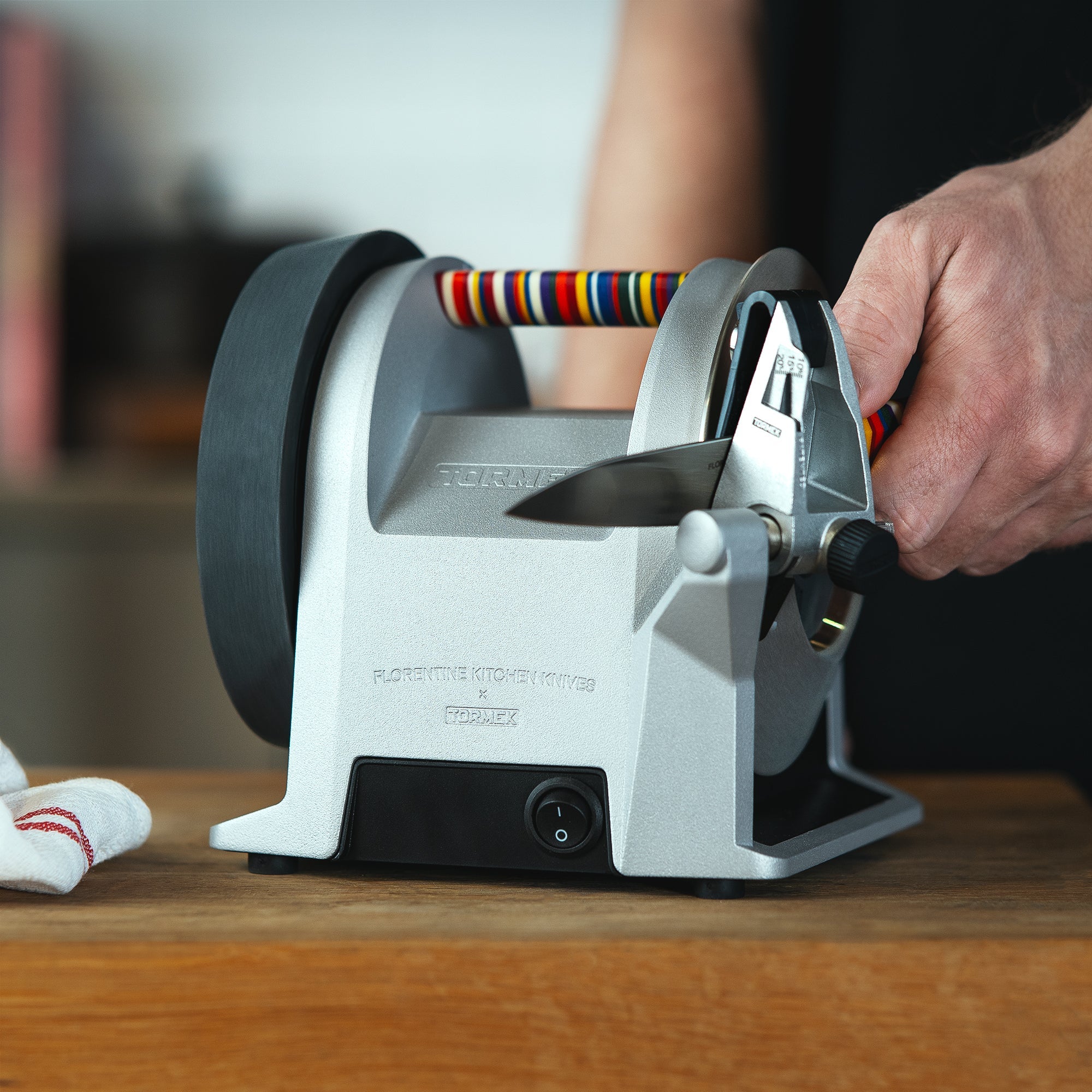 A picture of a person sharpening a knife on a Tormek T-1 Florentine Vibrant